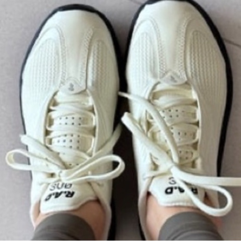 Cream and Black Athletic Shoes with Minimalist Design